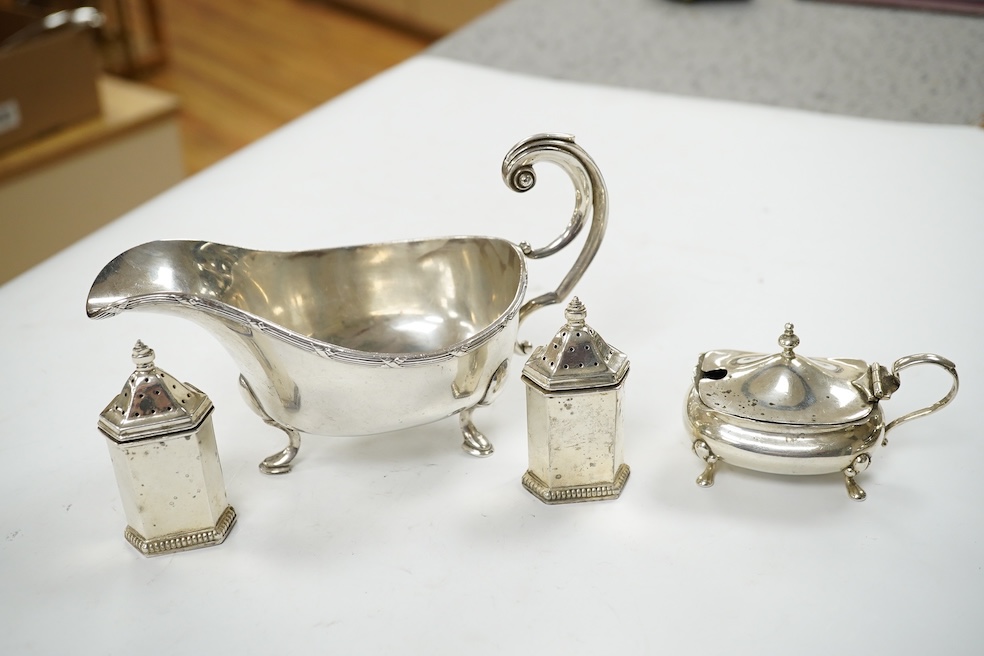 A modern silver sauceboat, 8.4oz and three silver condiments including a pair of pepperettes. Condition - fair